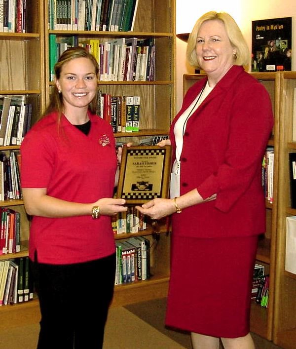 Professional Race Car Driver Sarah Fisher receives the first Pacesetter Award from Kathy Grove.